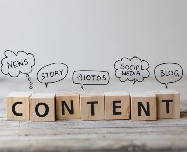 wooden blocks spelling content with bubbles describing aspects of content marketing