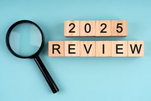 wooden blocks spelling out review next to magnifying glass representing seo