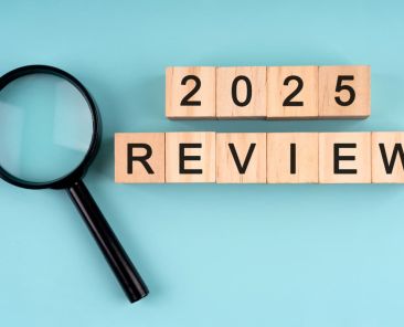 wooden blocks spelling out review next to magnifying glass representing seo