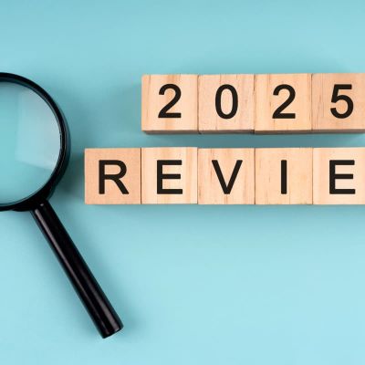 wooden blocks spelling out 2025 review next to magnifying glass representing seo