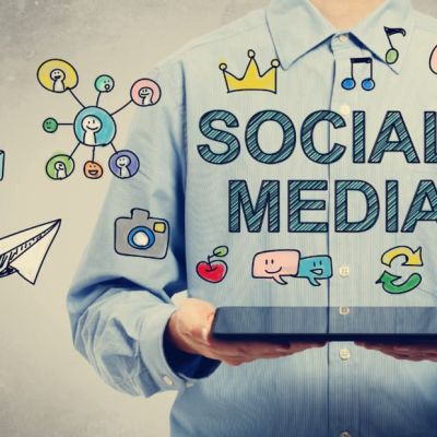 social media marketing concept drawn over man holding laptop
